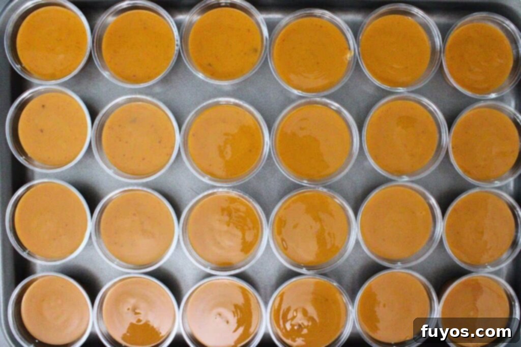 Transferring pumpkin pie pudding mix into individual shot cups
