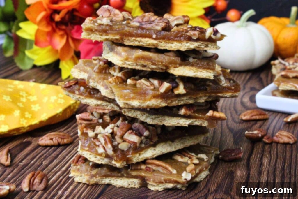 Easy Pecan Pie Toffee Bark 10 stack of no bake pecan pie bark with toffee topping on wooden counter with fall decor
