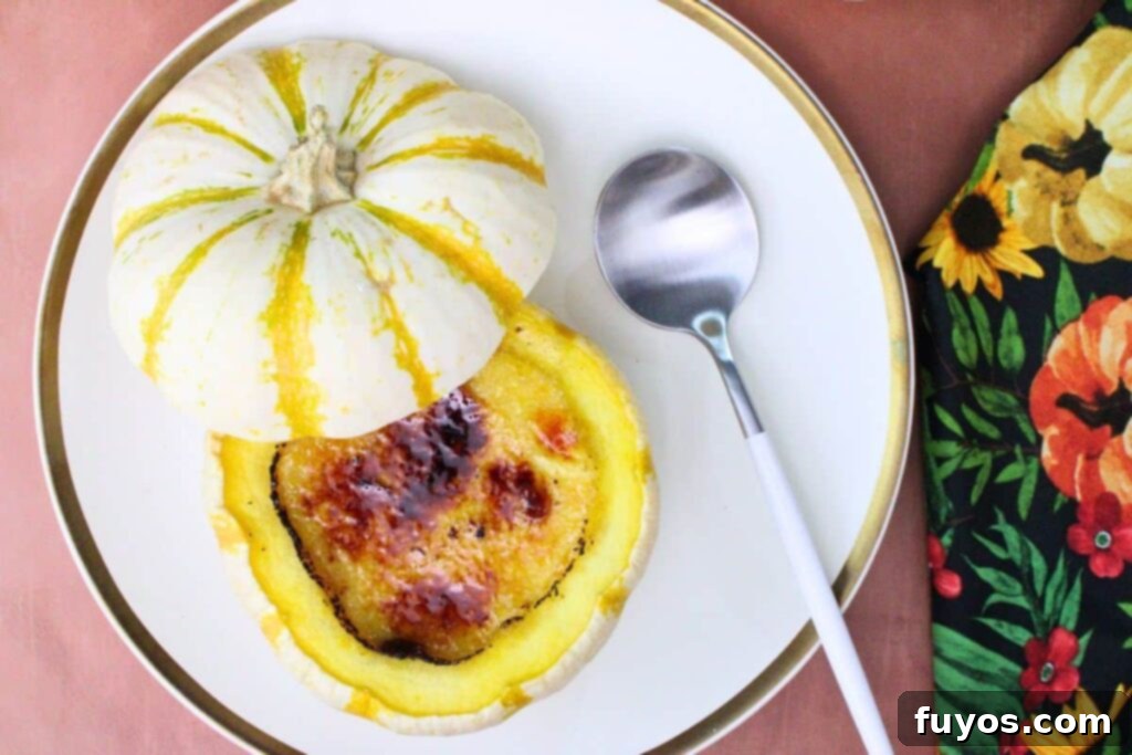 overhead view of pumpkin creme brulee in a mini pumpkin on a white plate next to a spoon
