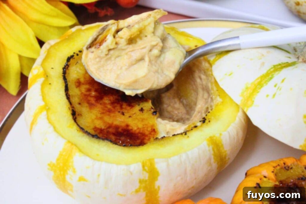 closeup view of a spoonful of pumpkin creme brulee on top of a mini pumpkin with more inside