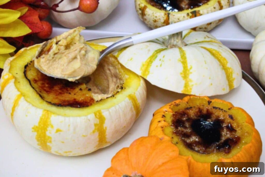 two pumpkin creme brulee desserts in mini pumpkins with a spoonful on top of one