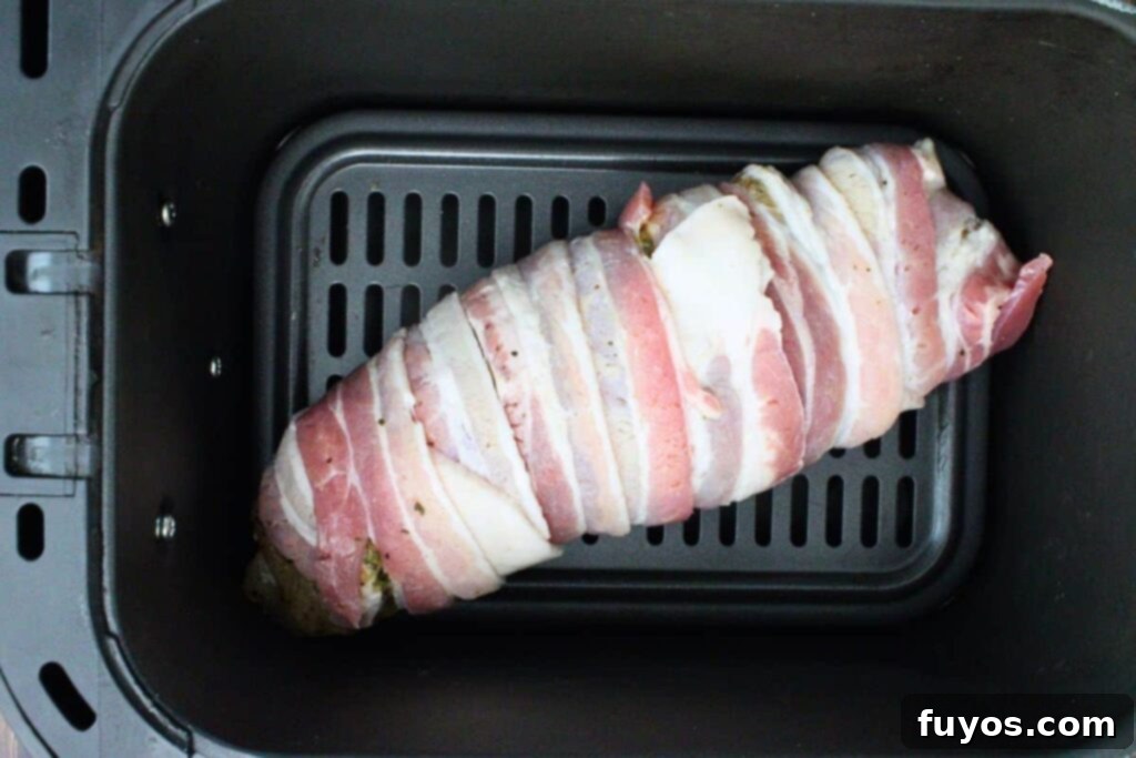 Easy Air Fryer BBQ Bacon Wrapped Turkey Tenderloin 6 place bacon wrapped turkey tenderloin in air fryer basket
