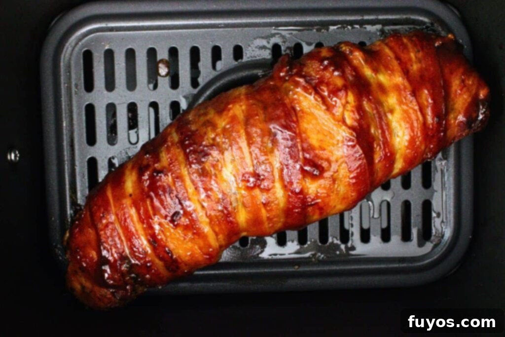 Easy Air Fryer BBQ Bacon Wrapped Turkey Tenderloin 7 brush bacon wrapped turkey tenderloin with bbq sauce and continue to cook