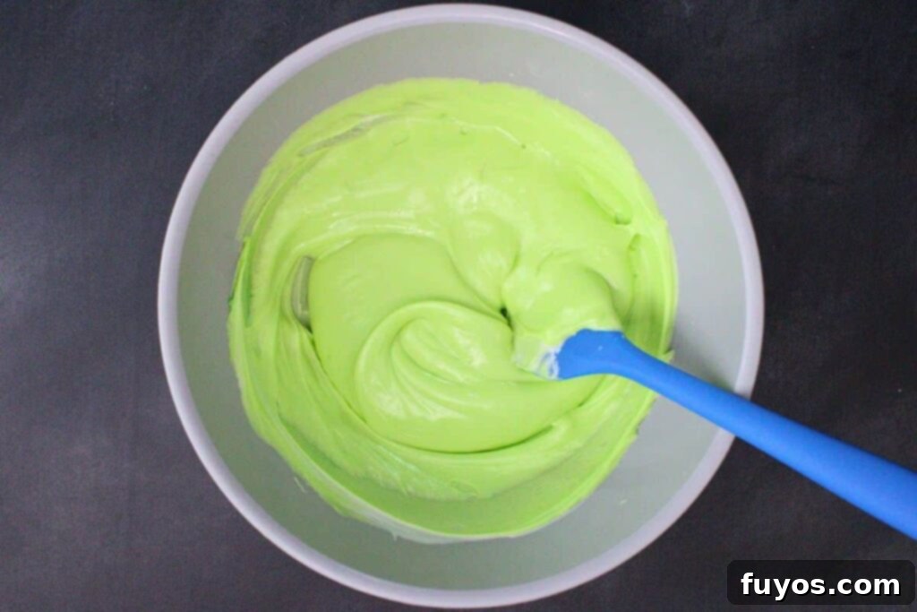 melt chocolate and green food coloring in microwave safe bowl