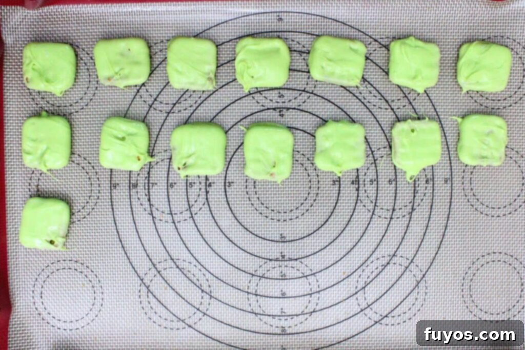 dip pretzel squares in melted green chocolate