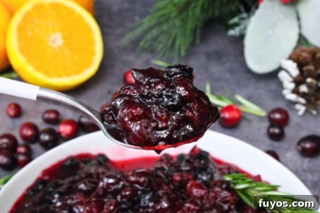 A spoonful of homemade microwave cranberry sauce, showcasing its vibrant deep red color and juicy texture