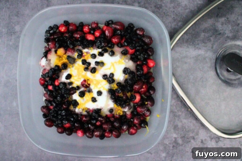 Cranberries, sugar, blueberries, orange juice, zest, and liqueur added to an Anyday microwave-safe glass dish