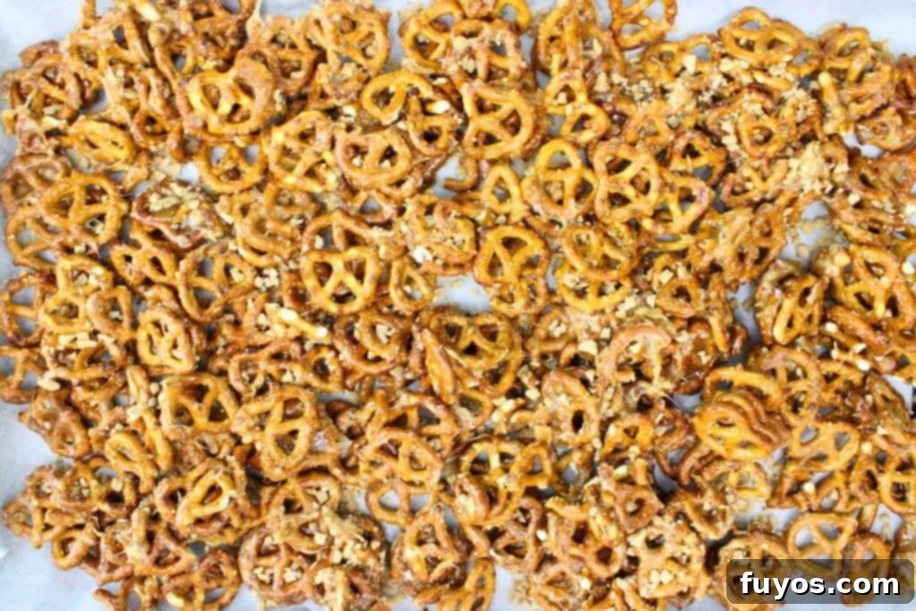 spread toffee coated pretzels on large parchment covered baking sheet