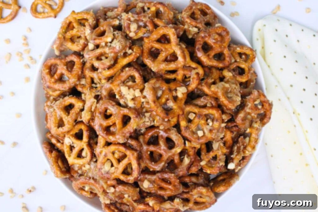 overhead view of butter toffee pretzels piled in a large white bowl on a counter