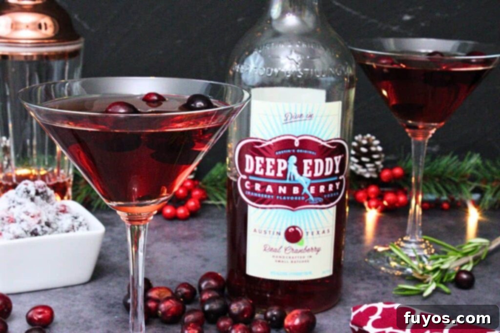 Effortless Holiday Cranberry Martini Vodka Drink 3 Close-up of a festive Cranberry Martini surrounded by winter decorations.
