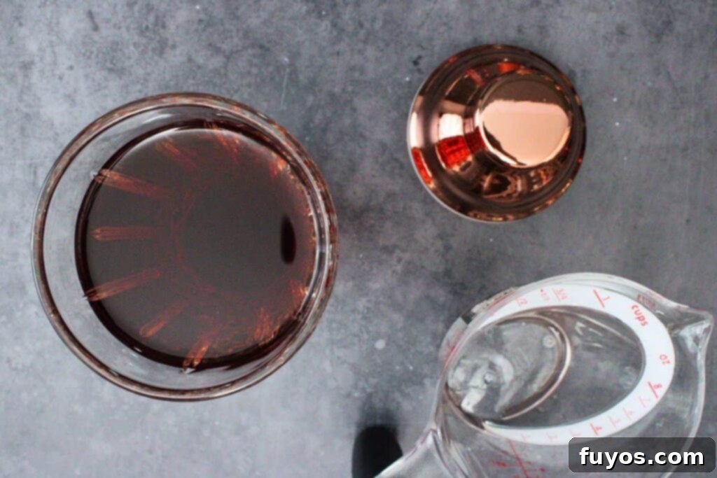 Effortless Holiday Cranberry Martini Vodka Drink 5 Adding vodka, triple sec, vermouth, and cranberry juice to a cocktail shaker.