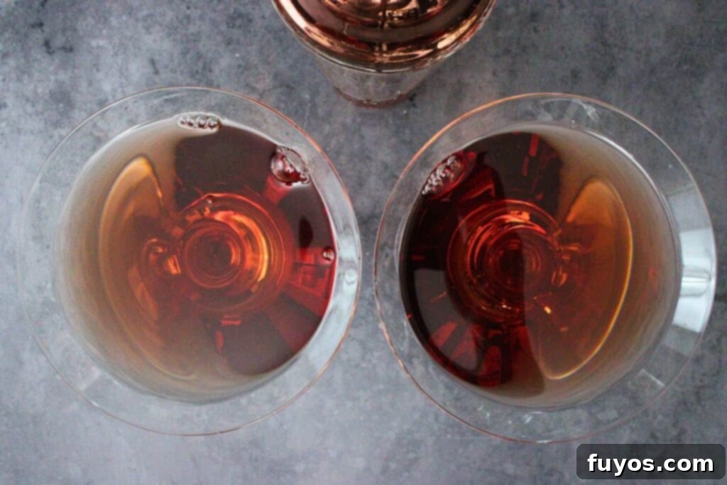 Effortless Holiday Cranberry Martini Vodka Drink 6 Straining a freshly shaken Cranberry Martini into a chilled martini glass.