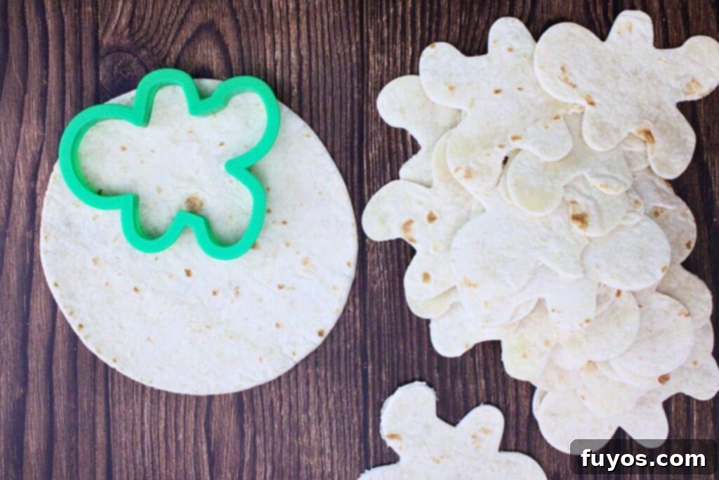 Gingerbread Nachos: A Festive & Fun Air Fryer Appetizer 5 Use gingerbread man cookie cutter to cut shapes in tortillas