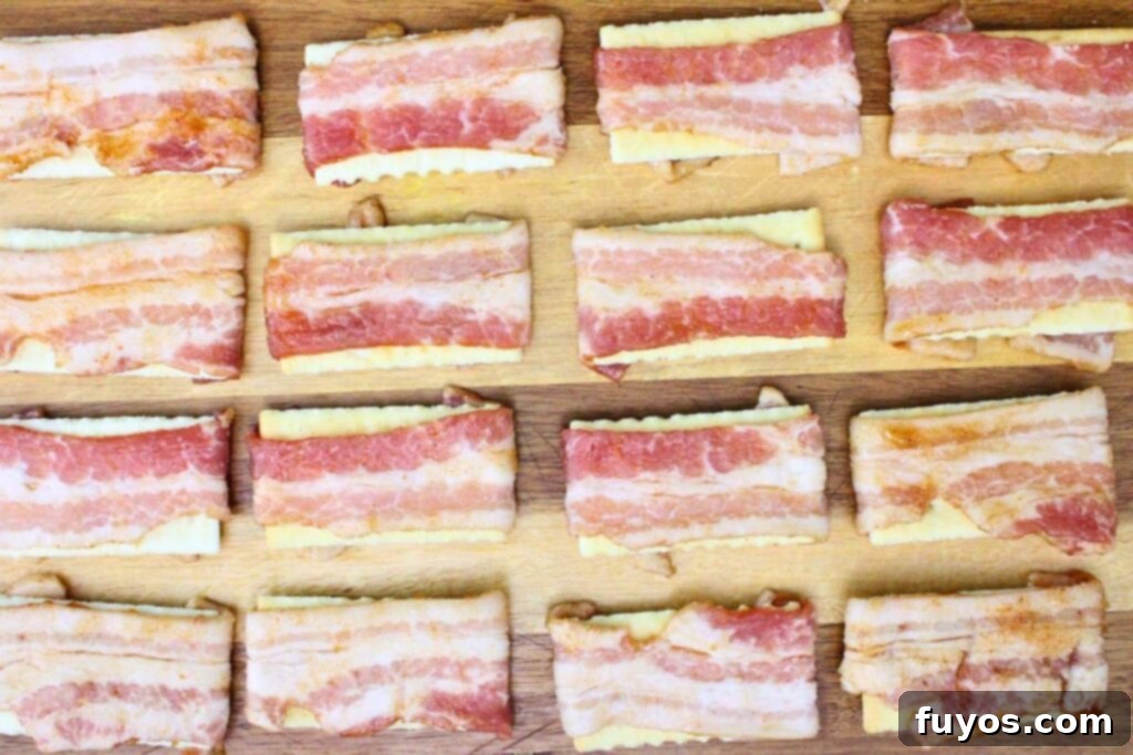 Crispy Air Fryer Bacon Bites: The Perfect Party Snack 6 Wrap each cracker in a slice of bacon, ensuring a secure fit