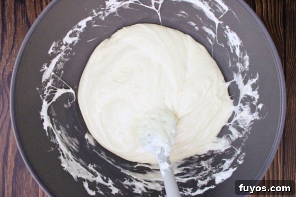 Melting marshmallows with white chocolate chips and butter in a microwave-safe bowl