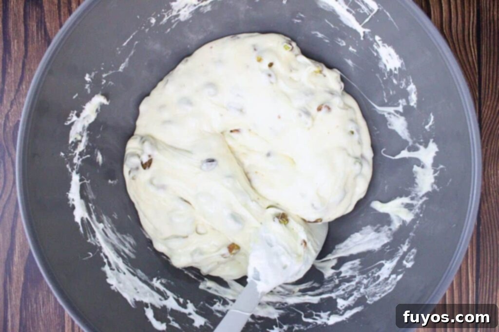 Folding honey and pistachios into the melted marshmallow mixture