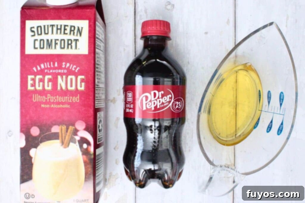 Dr Pepper Eggnog Rum Punch: A Festive Holiday Mixer 4 Dr Pepper, eggnog, and rum on a counter.