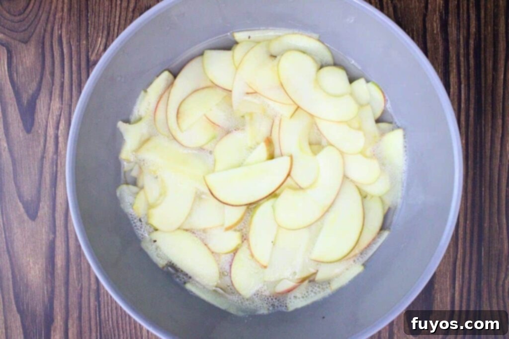 Place apple slices in a microwave-safe bowl with lemon juice and water