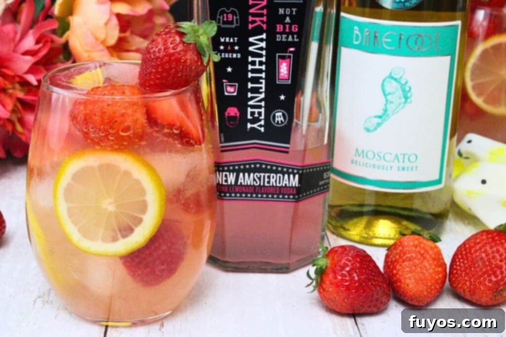 Pink Whitney Pink Lemonade Sangria 3 Ingredients for Giggle Juice cocktail with fresh strawberries and lemon