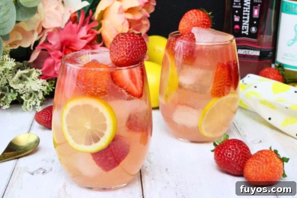 Pink Whitney Pink Lemonade Sangria 7 Two glasses of Giggle Juice with fresh strawberries and lemon