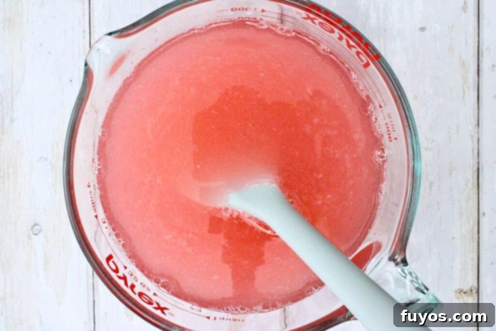 Stir in Pink Whitney vodka and remaining cold pink lemonade