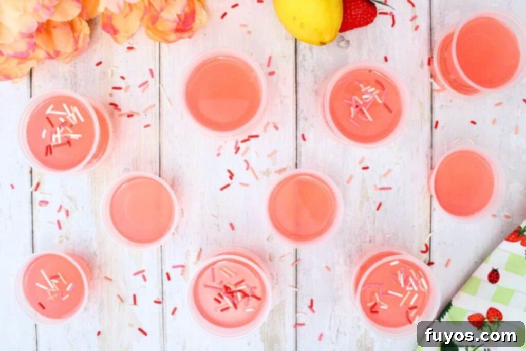 Overhead view of Pink Whitney Jello shots topped with sprinkles