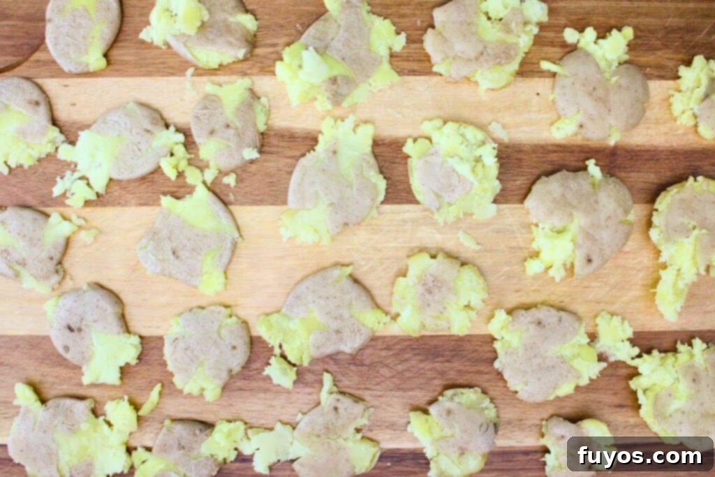 Air Fryer Smashed Potatoes with Garlic Parmesan Goodness 5 Use a glass to smash cleaned potatoes on a cutting board