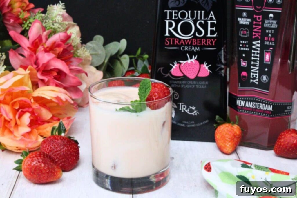 Pink Russian drink garnished with strawberry and mint