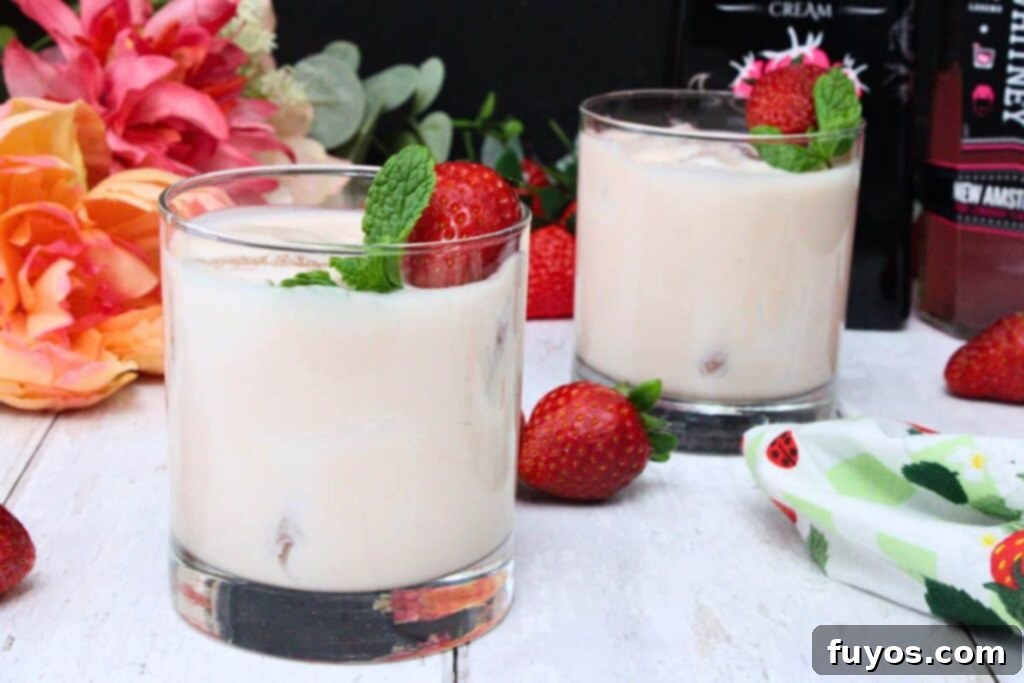 Two Pink Russian cocktails garnished with fruit and flowers