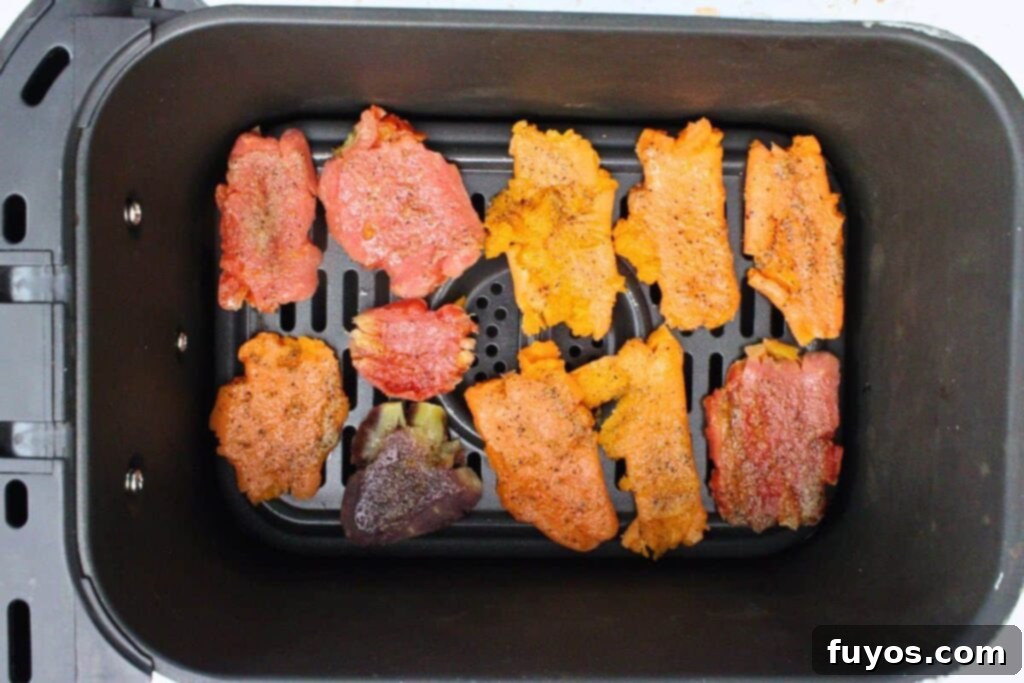 place seasoned smashed carrots in air fryer basket