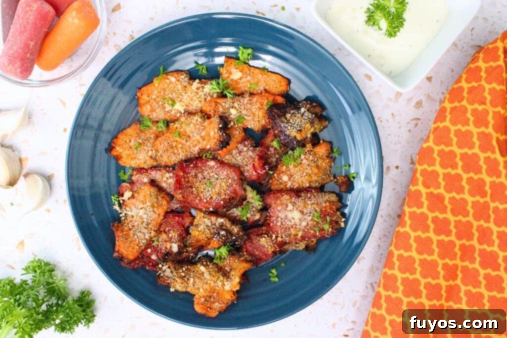 overhead view of air fryer garlic parmesan smashed carrots on a blue plate