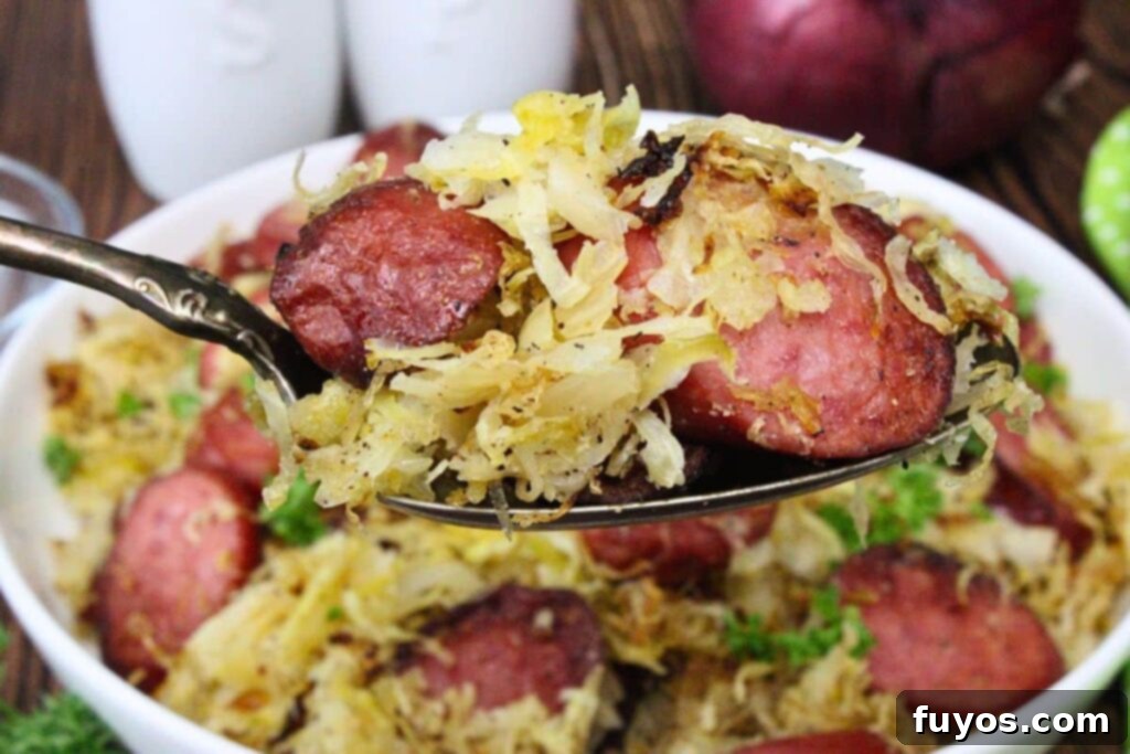 Forkful of air fryer kielbasa and sauerkraut
