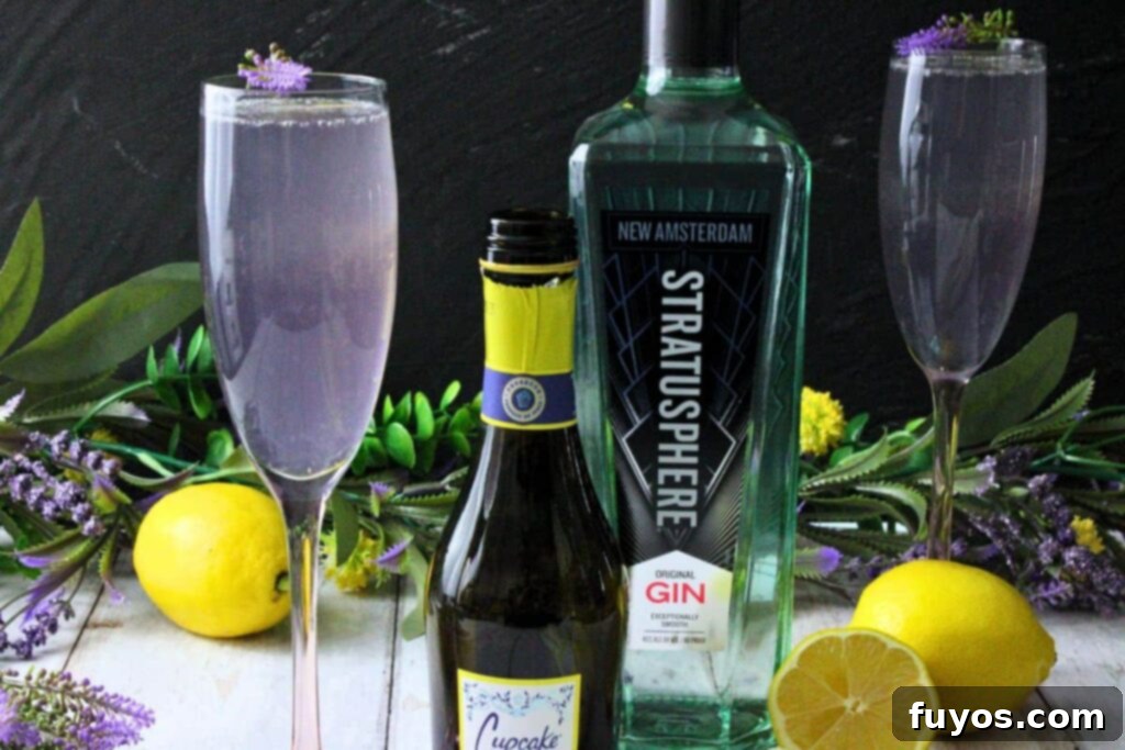 Lavender French 75: A Bubbly Spring Awakening 3 lavender french 75 next to champagne and gin bottles with fresh lemon and flowers