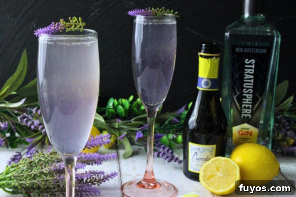 Lavender French 75: A Bubbly Spring Awakening 8 closeup of lavender french 75 garnished with lavender sprig next to a second drink with fresh lemon and bottles