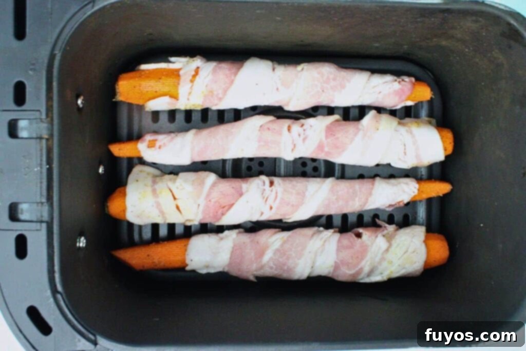 Air Fryer Bacon-Wrapped Carrots Drizzled with Hot Honey 7 Place bacon wrapped carrots in air fryer basket