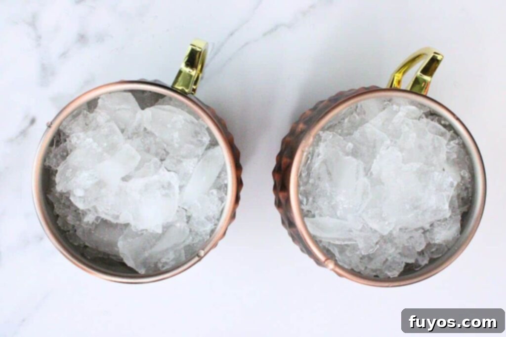 Blood Orange Bliss: A Zesty Vodka Ginger Beer Cocktail 5 Fill Copper Mug with Crushed Ice