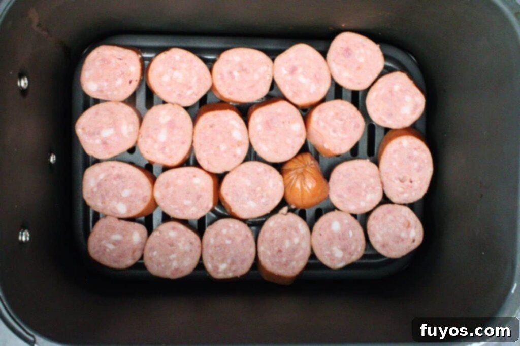 Air Fryer Kielbasa Bites: Sweet & Smoky Sensation 5 Sliced kielbasa in air fryer basket