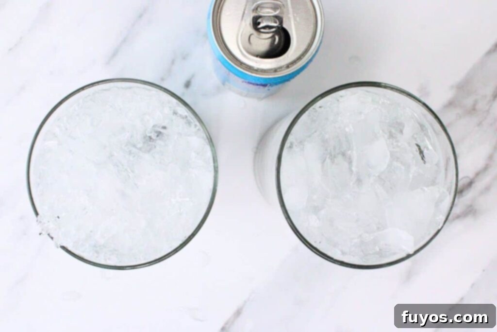 Lavender Mojito: Aromatic Spring Refresher 6 Filling a lavender mojito glass with crushed ice and club soda, showcasing the refreshing bubbles.