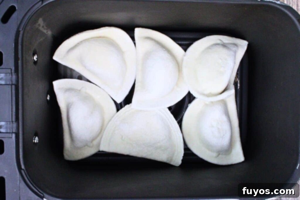 Add frozen pierogies to air fryer basket