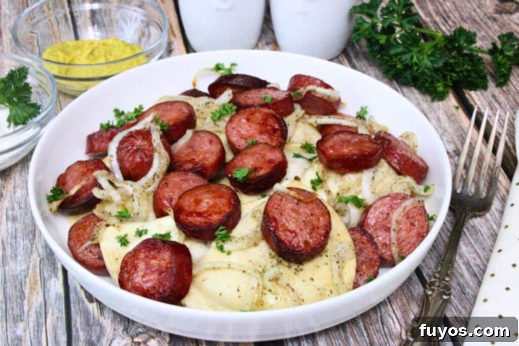 Shallow bowl of kielbasa and pierogies with onions and parsley on rustic wooden table
